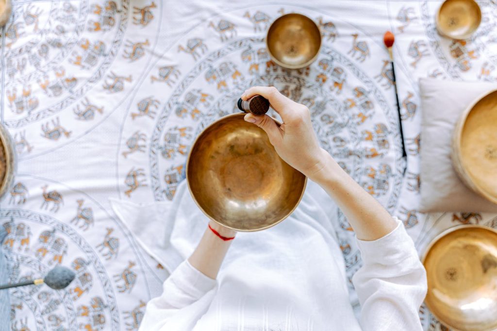 person-holding-a-tibetan-singing-bowl-6252093 A top-down view of meditation using a Tibetan singing bowl for relaxation and healing.